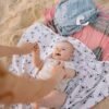 pexels-photo-5791414-5791414 A joyful baby on the beach with parent, enjoying playtime on a sunny day.