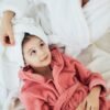 pexels-photo-6202202-6202202 Mother and daughter in bathrobes sharing a relaxing moment indoors, epitomizing comfort and togetherness.