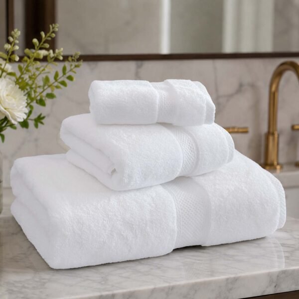samifyhome-luxury-white-towel-set-bathroom-display Close-up of Samifyhome luxury white bath, hand, and face towels stacked in a bathroom